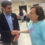 Hampden District Attorney Anthony Gulluni shakes hands with a person at an event.