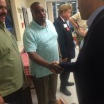 Hampden District Attorney Anthony Gulluni shakes hands with a person at an event.