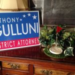 A table with a Hampden District Attorney Anthony Gulluni campaign sign.