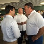 Hampden District Attorney Anthony Gulluni talks with a person at an event.