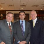 Hampden District Attorney Anthony Gulluni poses for a photo with two people.