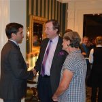 Hampden District Attorney Anthony Gulluni talks with two people at an event.