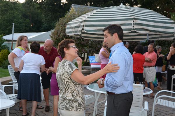 Hampden District Attorney Anthony Gulluni talks with a person at an event.