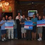 Hampden District Attorney Anthony Gulluni poses for a photo with a group of people at a campaign event.