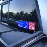 A bumper sticker for Hampden District Attorney Anthony Gulluni displayed on a car.