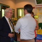 Three people talking to one another at an event.