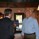 Hampden District Attorney Anthony Gulluni talks with a person at an event.