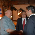 Hampden District Attorney Anthony Gulluni shakes hands with a person at an event.