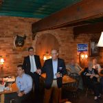 Hampden District Attorney Anthony Gulluni laughs as a person talks at a campaign event.