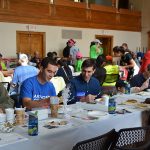 Hampden District Attorney Anthony Gulluni eats with a group of people at an event.