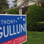 A lawn sign for Hampden District Attorney Anthony Gulluni outside a venue.