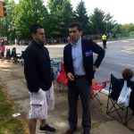 Hampden District Attorney Anthony Gulluni talks to a person at an outside event.