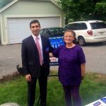 Hampden District Attorney Anthony Gulluni poses for a photo with a person outside at a campaign event.