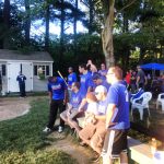 A wiffle ball team watching the game.