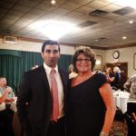 Hampden District Attorney Anthony Gulluni poses for a photo with another person at an event.