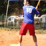 A person about to swing a wiffle ball bat.