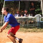 A person begins to run at a wiffle ball tournament.