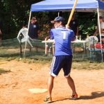 Someone about to swing a wiffle ball bat.