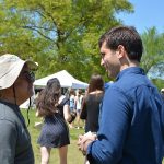 Hampden District Attorney Anthony Gulluni talks to a person at an outside event.