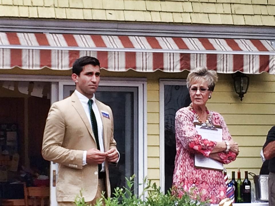 Hampden District Attorney Anthony Gulluni and another woman stand at an event.