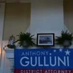 A mantle with a banner supporting Hampden District Attorney Anthony Gulluni's campaign hanging over it.