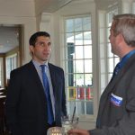 Hampden District Attorney Anthony Gulluni talks to a person who is wearing a sticker in support of Gulluni's campaign.