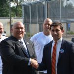 Hampden District Attorney Anthony Gulluni shakes hands with a person at an event.