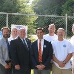 Hampden District Attorney Anthony Gulluni poses for a photo with a group of people.