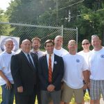 Hampden District Attorney Anthony Gulluni poses for a photo with a group of people.