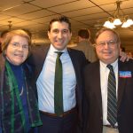 Hampden District Attorney Anthony Gulluni smiles and poses for a photo with two other people.