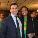 Hampden District Attorney Anthony Gulluni smiles for a photo with a person at a party.