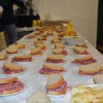 A table covered with sandwiches.
