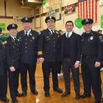 Hampden District Attorney Anthony Gulluni poses for a photo with six police officers.