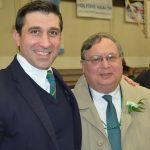 Hampden District Attorney Anthony Gulluni poses for a photo with a person.