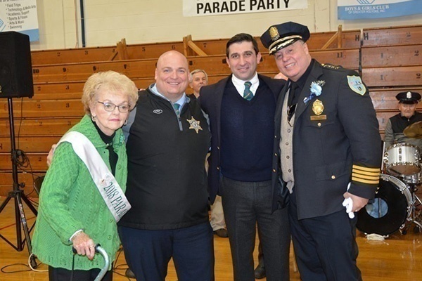 Hampden District Attorney Anthony Gulluni and Hampden County Sheriff Nicholas Cocchi pose for a photo with two other people.
