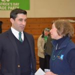 Hampden District Attorney Anthony Gulluni talks to another person at an event.