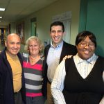 Hampden District Attorney Anthony Gulluni poses for a photo with three people.