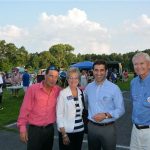 Hampden District Attorney Anthony Gulluni poses for a photo with three others at an outdoor event.