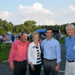 Hampden District Attorney Anthony Gulluni poses for a photo with three others at an outdoor event.