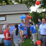 Hampden District Attorney Anthony Gulluni talks to people at an outdoor event.