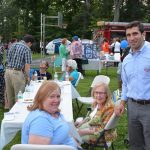 Hampden District Attorney Anthony Gulluni poses for a photo with two other people at an outdoor event.