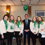 Hampden District Attorney Anthony Gulluni poses for a photo with five girls wearing matching outfits.