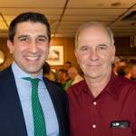 Hampden District Attorney Anthony Gulluni smiles and poses for a photo with a man.