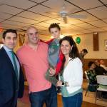 Hampden District Attorney Anthony Gulluni poses alongside a man holding a child and a woman.