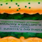 A cake that reads "Hampden District Attorney Anthony Gulluni's Fourth Annual St. Patrick's Day Party."