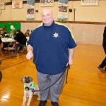Hampden Sheriff Nicholas Cocchi poses with a dog on a leash.