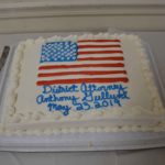 A cake with an American flag on it that reads "District Attorney Anthony Gulluni May 23, 2019."
