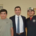 Hampden District Attorney Anthony Gulluni poses for a photo with two men.