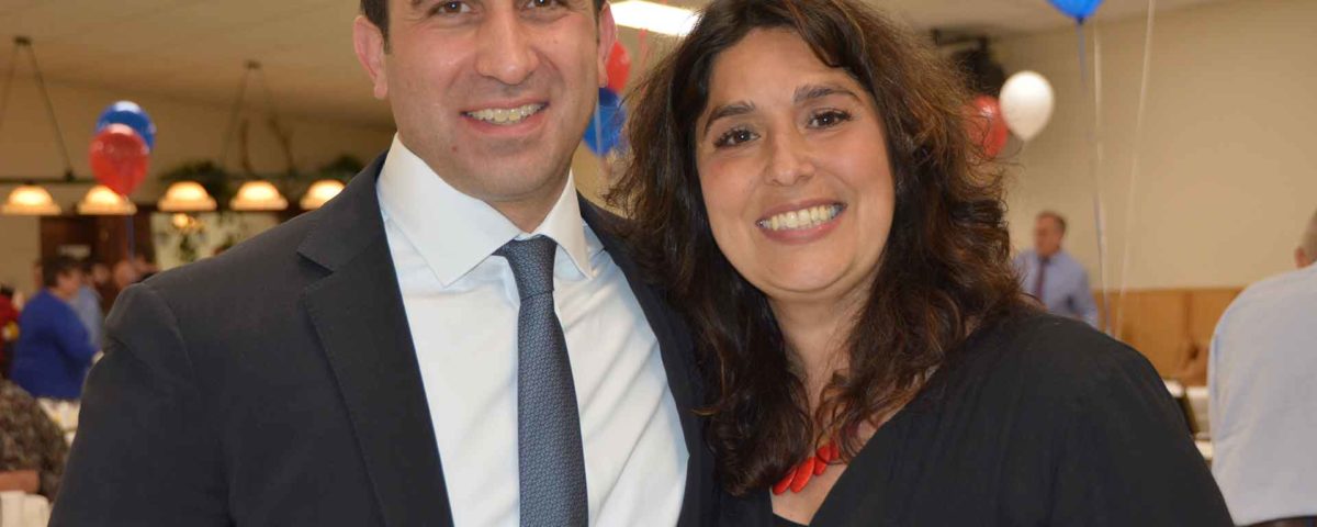 Hampden District Attorney Anthony Gulluni poses for a photo with a woman.