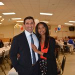 Hampden District Attorney Anthony Gulluni smiles and poses for a photo with a woman.